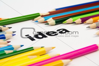 many colored pencils arranged around the word idea