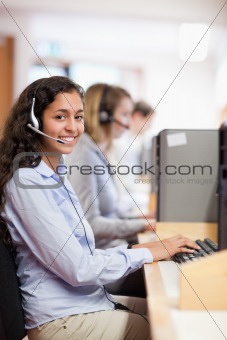 Portrait of a smiling assistant working with a computer