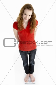 Happy Young Girl Standing On Scales