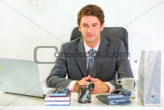Portrait of happy modern businessman in office
