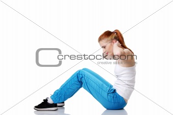 Teen student doing exercises on the floor.