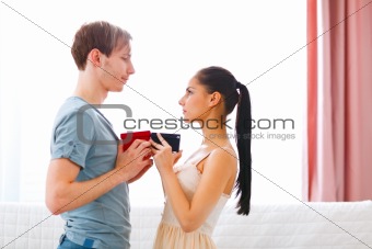 Romantic couple exchanging gifts

