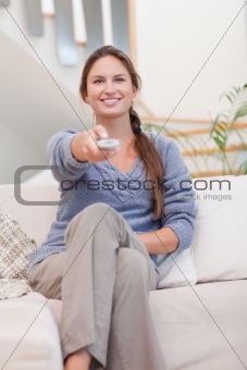 Portrait of a happy woman woman watching TV
