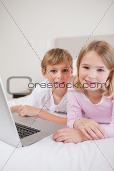Portrait of cute children using a laptop