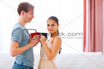 Young couple exchanging gifts
