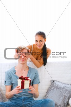 Young woman cover eyes to waiting present boyfriend
