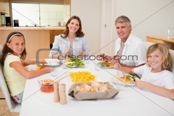 Smiling family having dinner