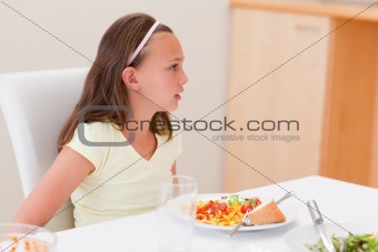 Girl with dinner at the table