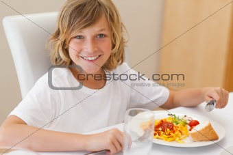 Smiling boy having dinner
