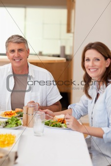 Happy couple eating dinner