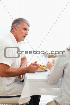 Side view of man having dinner