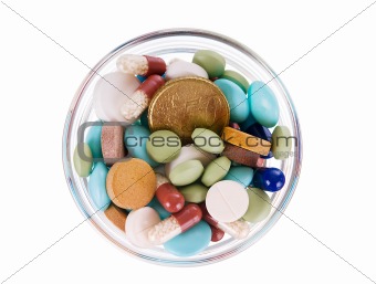 Fifty euro cents in saucer full of pills