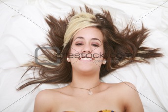 Woman lying in bed smiling 