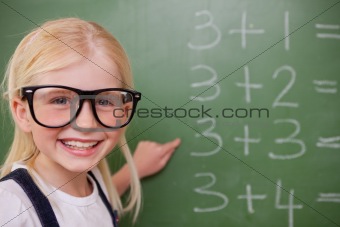 Smart schoolgirl pointing at something