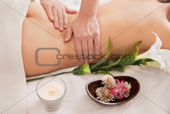 An attractive lying down on a massage bed
