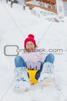The girl goes for a drive on an snow slope.
