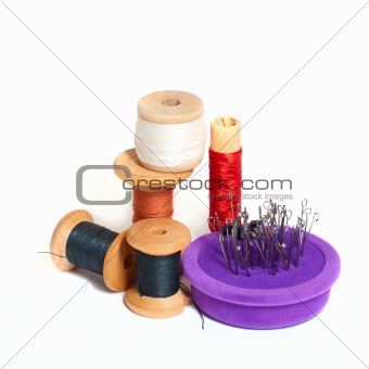 Group of spools with thread and needle bed