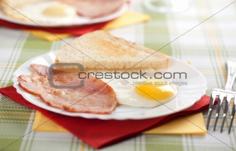 Breakfast. Eggs, toasts and bacon