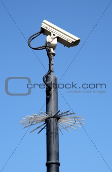 Street security cctv camera and a blue sky.