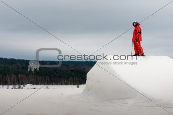 Skier standing on springboard peak