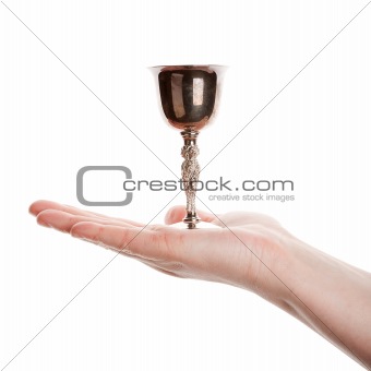 Female hand holding silver goblet