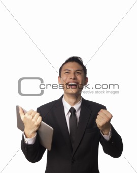 Young Asian Corporate Man with Tablet PC and Clenching his Fists Over white Background