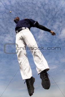 baseball player jumping and catching the ball