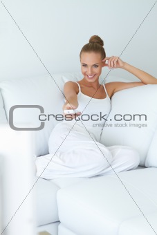 Cute woman watching tv on sofa