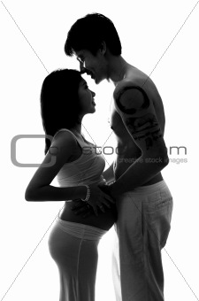 Silhouette of pregnant lady and husband