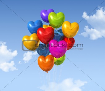 colored heart shape balloons on a blue sky