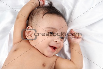 Smiling Baby on white satin background