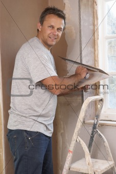 Plasterer Working On Interior Wall
