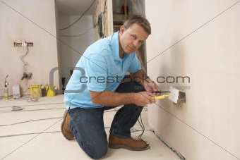 Electrician Installing Wall Socket