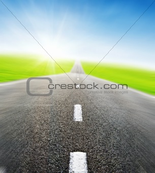 road over blue sky in motion