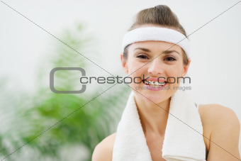 Portrait of smiling fitness woman with towel