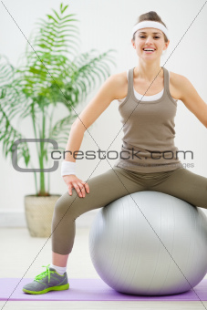 Fitness woman sitting on fitness ball