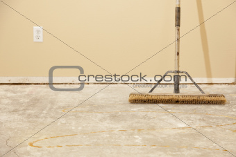 Blank Concrete House Floor with Broom Ready for Flooring Installation.