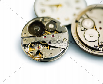 Old metal mechanical clock with gear wheels on a white background