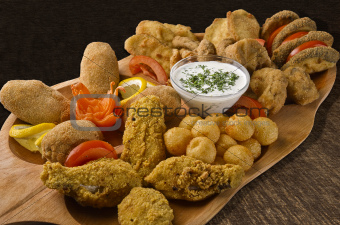 Rustic tray with various meats and cheese balls - isolated
