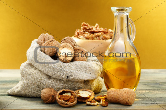 Walnut oil in bottle and nuts.