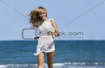 Sexy blonde woman running windblown