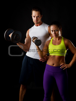 Couple doing dumbbell lifts