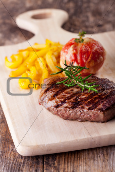 grilled steak with fries and tomato 