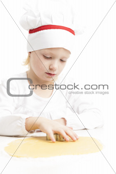 little girl cutting cookies