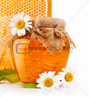 sweet honey in glass jars with flowers