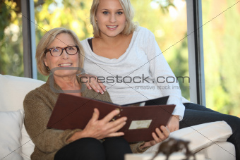 Grandmother and granddaughter looking at pictures