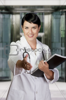 Smiling medical doctor with stethoscope. Over hospital backgroun