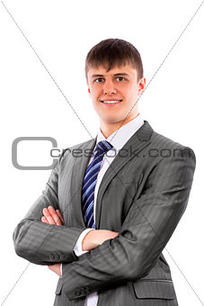 Young businessman poses confidently with crossed arms