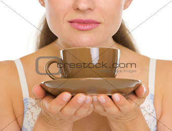 Closeup on cup of coffee in woman hands