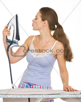 Young woman in pajamas enjoying new iron